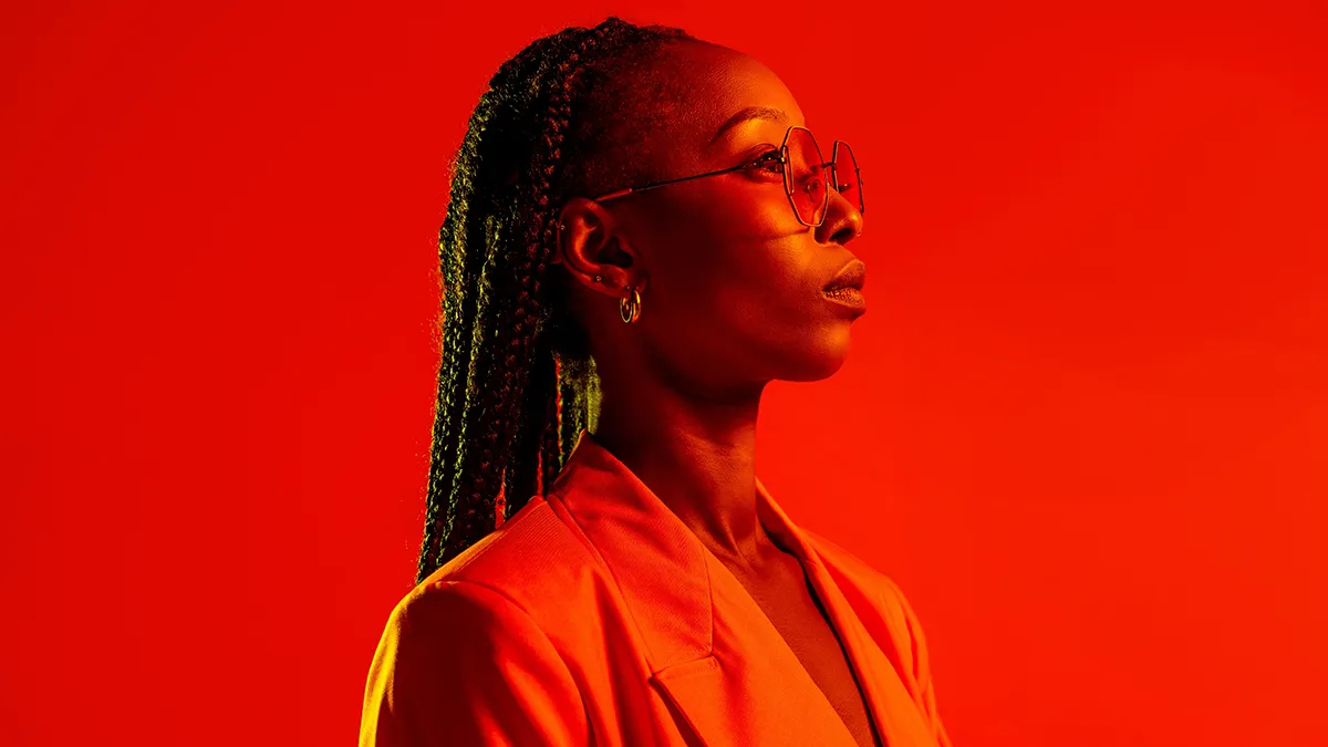 An African-American woman in red lights